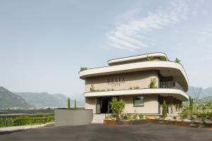 a building with a lot of plants in front of it at Belia Lofts - ADULTS ONLY - Apartments in Appiano sulla Strada del Vino
