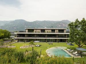 a large building with a garden and a swimming pool at Belia Lofts - ADULTS ONLY - Apartments in Appiano sulla Strada del Vino