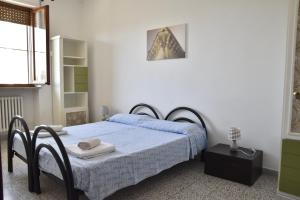 a bedroom with a bed and a table with towels on it at VERETO apartaments Lecce in Lecce