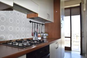 a kitchen with a stove and a counter top at VERETO apartaments Lecce in Lecce +9 photos