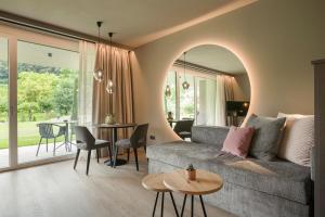 a living room with a couch and a table at Belia Lofts - ADULTS ONLY - Apartments in Appiano sulla Strada del Vino