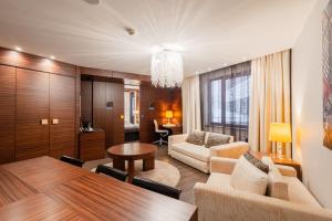 a living room with a couch and a table at Tallink Hotel Riga in Riga +43 photos
