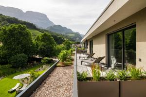 a house with a view of a garden at Belia Lofts - ADULTS ONLY - Apartments in Appiano sulla Strada del Vino