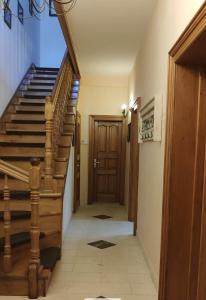 a hallway with stairs and a wooden door at Old House - Ferienhaus in Selce