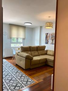 a living room with a couch and a table at Apartamento nuevo en Zona Baja de Cotolino in Castro-Urdiales