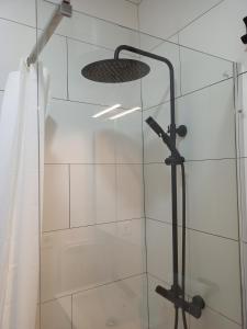 a shower with a glass door with a shower head at La Casita de Las Eras in Níjar +23 photos