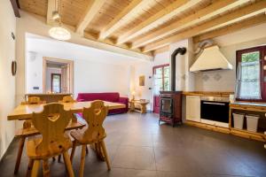 a kitchen and living room with a table and chairs at Agriturismo Malga Riondera in Ala +104 photos
