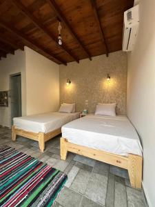 two beds sitting next to each other in a room at Balance Lodges in Dahab