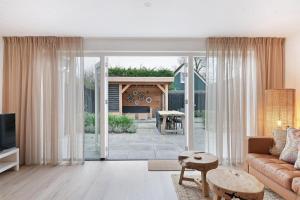 a living room with a couch and a fireplace at Jonkerstee 217 - Ouddorp - NOT FOR COMPANIES in Ouddorp