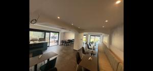 a dining room with chairs and tables in a room at Ambassador & Ambassador Lux Apartments in Ulcinj