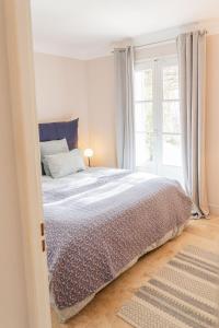 a bedroom with a large bed and a window at Maison avec piscine in Aix-en-Provence +12 photos