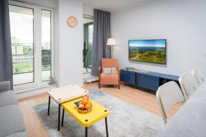 a living room with a couch and a table at Centaurus 49 by RENT4YOU in Olsztyn