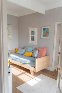 a couch with colorful pillows in a room at Maison avec piscine in Aix-en-Provence