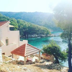 a house with a view of a river at Robinson Medvidina Bay in Zastražišće +10 photos