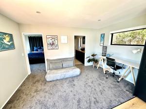 a living room with a desk and a bedroom at Stunning house with amazing view in Diamond Harbour