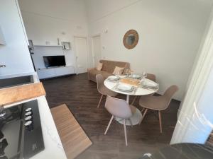 a kitchen and living room with a table and chairs at North Wind Luxury Home in Vieste +26 photos