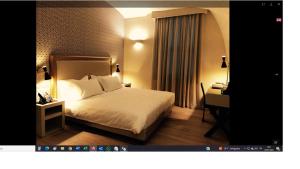 a hotel room with a bed and a desk at Caruso Place Boutique & Wellness Suites in Naples