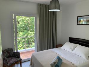 a bedroom with a bed and a window and a chair at Apartment in Kyrenia, Cyprus in Kérynia