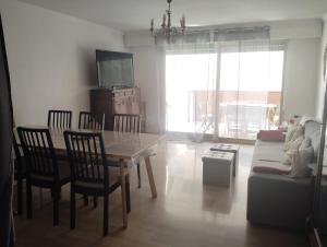 a living room with a table and chairs and a couch at T3 avec piscine et proche de la mer 5mns à pied in Saint-Raphaël