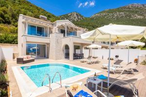 an image of a villa with a swimming pool at Villa Alora in Barbati