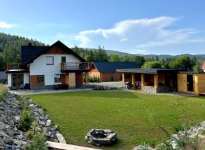 a home with a large yard with a house at Domek SAMI SWOI in Zawoja