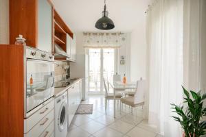 a kitchen with a table and a dining room at Mistral Suite Apartment - free private car park in Bari