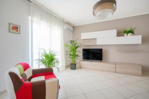 a living room with a tv and a couch at Mistral Suite Apartment - free private car park in Bari