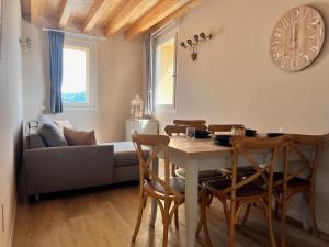 a living room with a table and a couch at Antica Corte - Lake view in Montinelle
