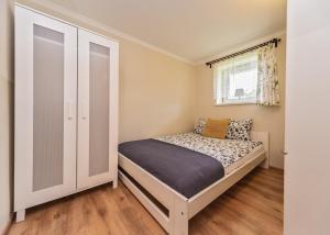 Łóżko lub łóżka w pokoju w obiekcie Willa Aleksandra - Apartamenty
