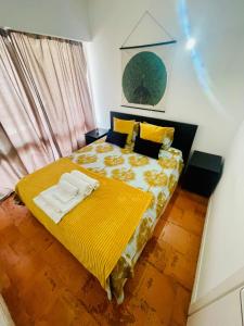 a bedroom with a bed with a yellow blanket at Boutique Two Bedrooms Apartament Praia Da Oura in Albufeira