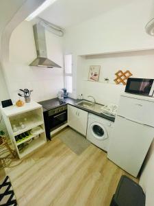 a kitchen with a sink and a washing machine at Boutique Two Bedrooms Apartament Praia Da Oura in Albufeira