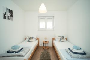 a room with two beds and a window at Villa Paradise On The River in Blagaj