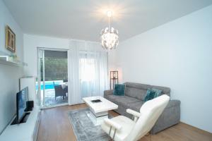 a living room with a couch and a table at Villa Paradise On The River in Blagaj