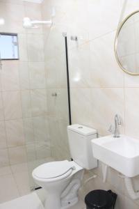 a bathroom with a toilet and a sink at Liziane Souza da Silva in Catarina +25 photos