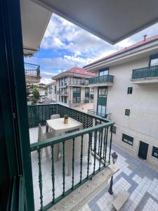 a balcony with a table and a view of a building at TAKE Arena in Nigrán