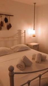 a white bed with two pillows on top of it at Traditional suites in Chora Kythnos #7 in Kithnos