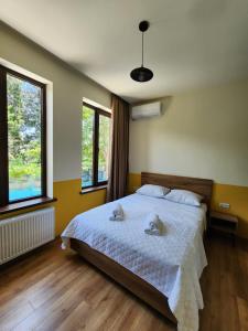 a bedroom with a bed with two stuffed animals on it at DRO Hotel in Kutaisi