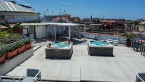 two people in hot tubs on top of a roof at B&B Sweet Sleep in Naples