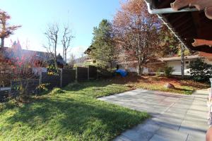 a yard with a fence and a driveway at Les Jumelles in Gstaad