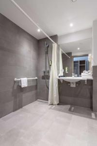 a bathroom with a shower and a sink at Best Western Hotel Kiefersfelden in Kiefersfelden