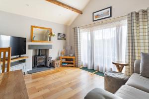 a living room with a couch and a television at The Blue Duck in Hawkshead