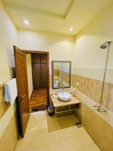 a bathroom with a sink and a shower at Shelton's Rezidor Hotel Gulberg Lahore in Lahore +26 photos