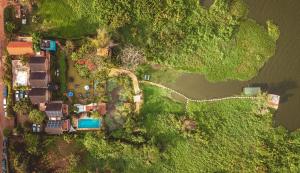 an aerial view of a house and a road next to a river at Yellow Haven Lodge in Kampala