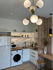 a kitchen with a white refrigerator and a dishwasher at K & L Luxury Suite in Parga