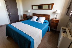A bed or beds in a room at La Torre del Vilar