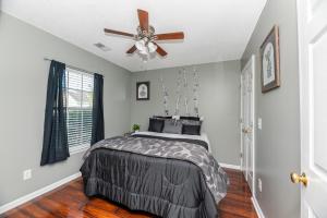 a bedroom with a bed and a ceiling fan at Stoney Oasis in Charleston