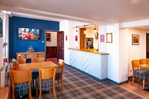 a kitchen and dining room with a table and chairs at Claxton Hotel in Redcar