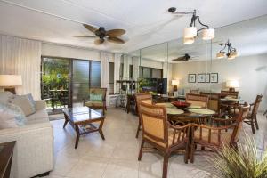 a dining room and living room with a table and chairs at Kihei Akahi Resort - Unit C313 in Wailea