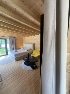 a bedroom with a bed and a yellow chair at chalet Arena in Porto-Vecchio +43 photos