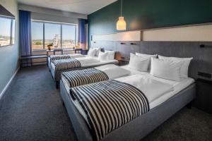 A bed or beds in a room at Comwell Aarhus Dolce by Wyndham